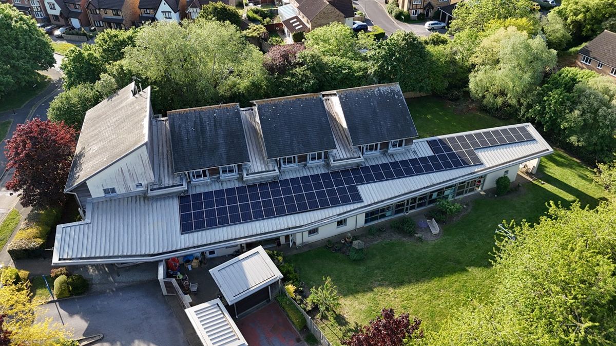 Aerial view of a commercial building with rooftop solar